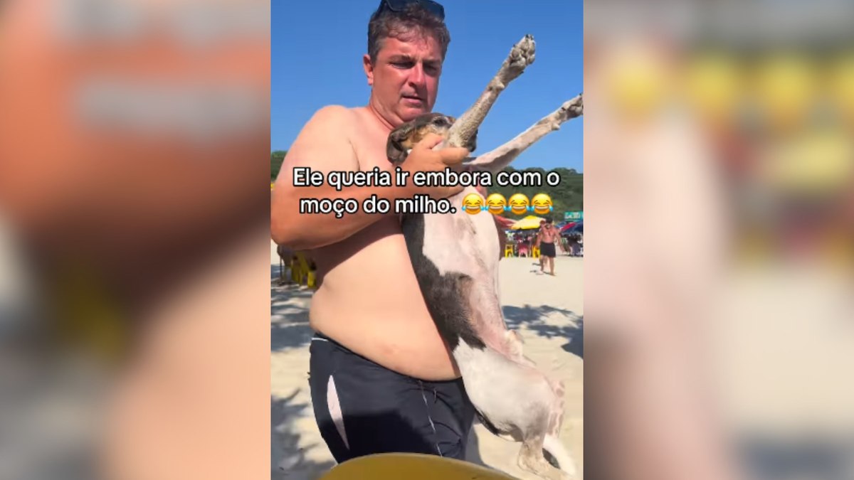 Cachorrinho tenta escapar de dono para seguir vendedor de milho